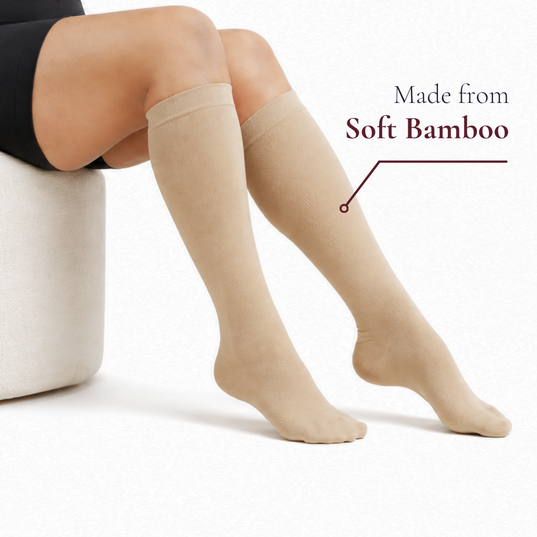Beige Movira bamboo wide-calf compression socks worn by a woman, labelled Made from Soft Bamboo