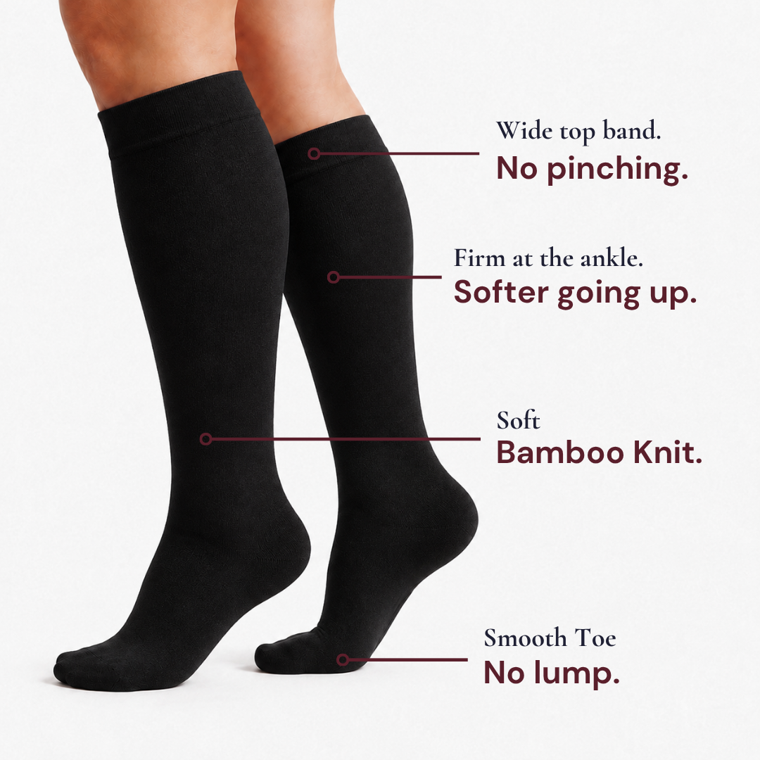Black Movira bamboo wide-calf compression socks worn on a woman's legs