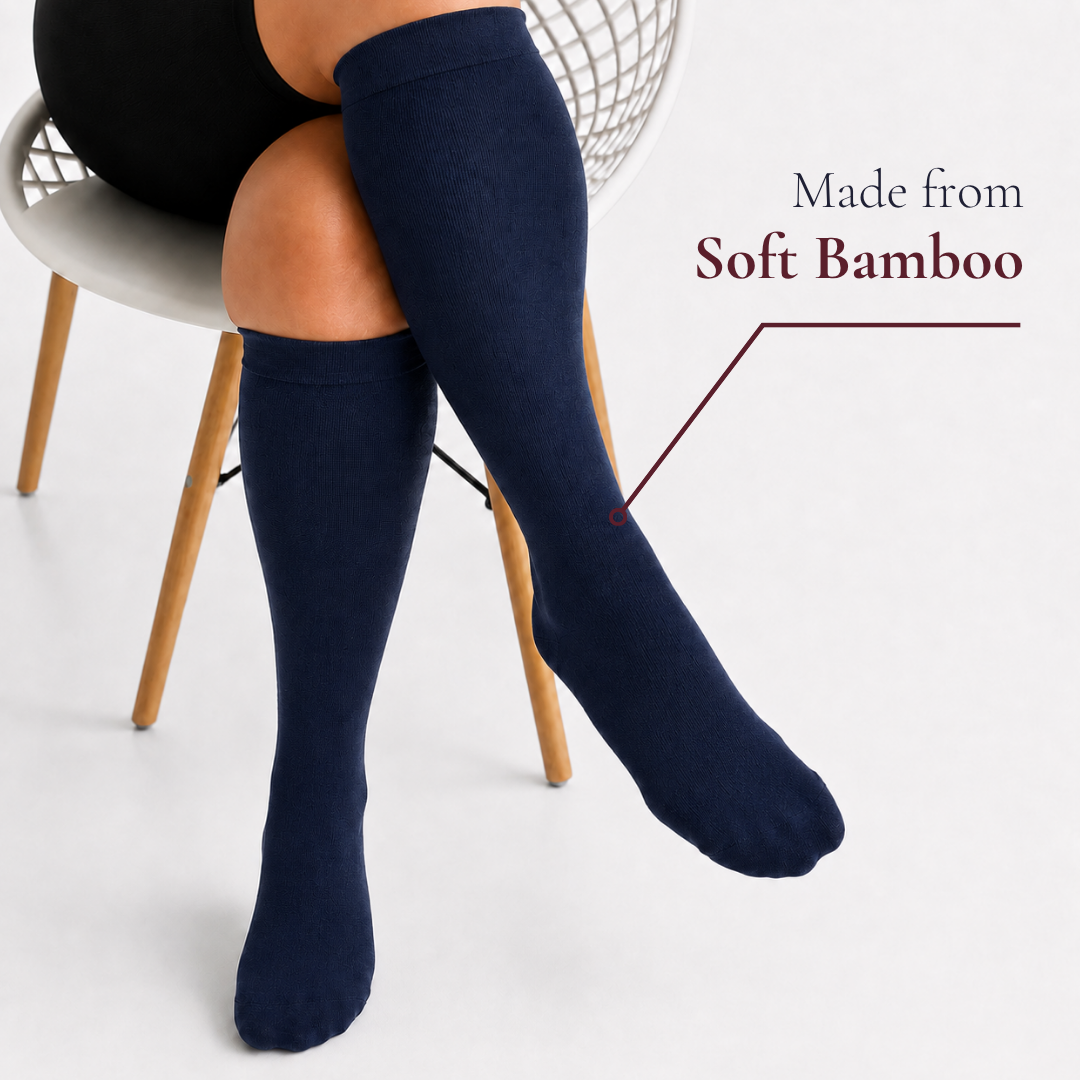 Navy blue Movira bamboo wide-calf compression socks worn by a woman