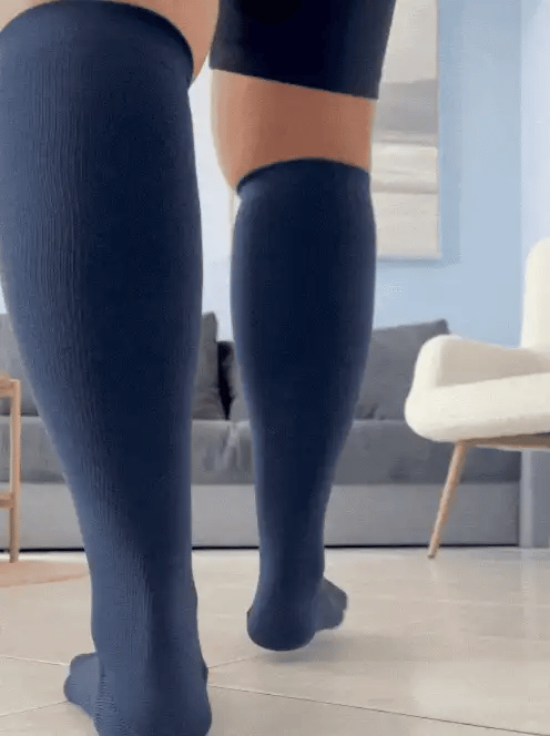Woman with wider calves walking comfortably in navy Movira bamboo wide-calf compression socks